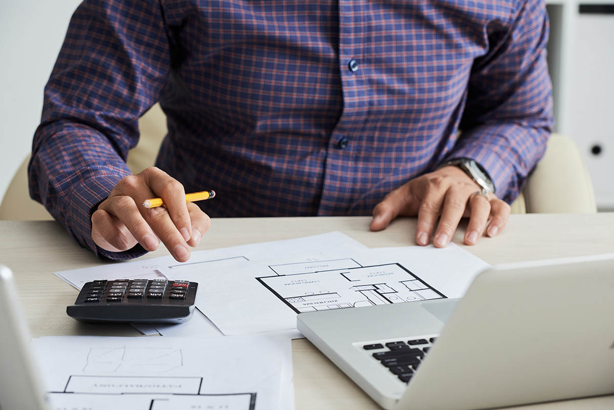 man calculating costs of renovation