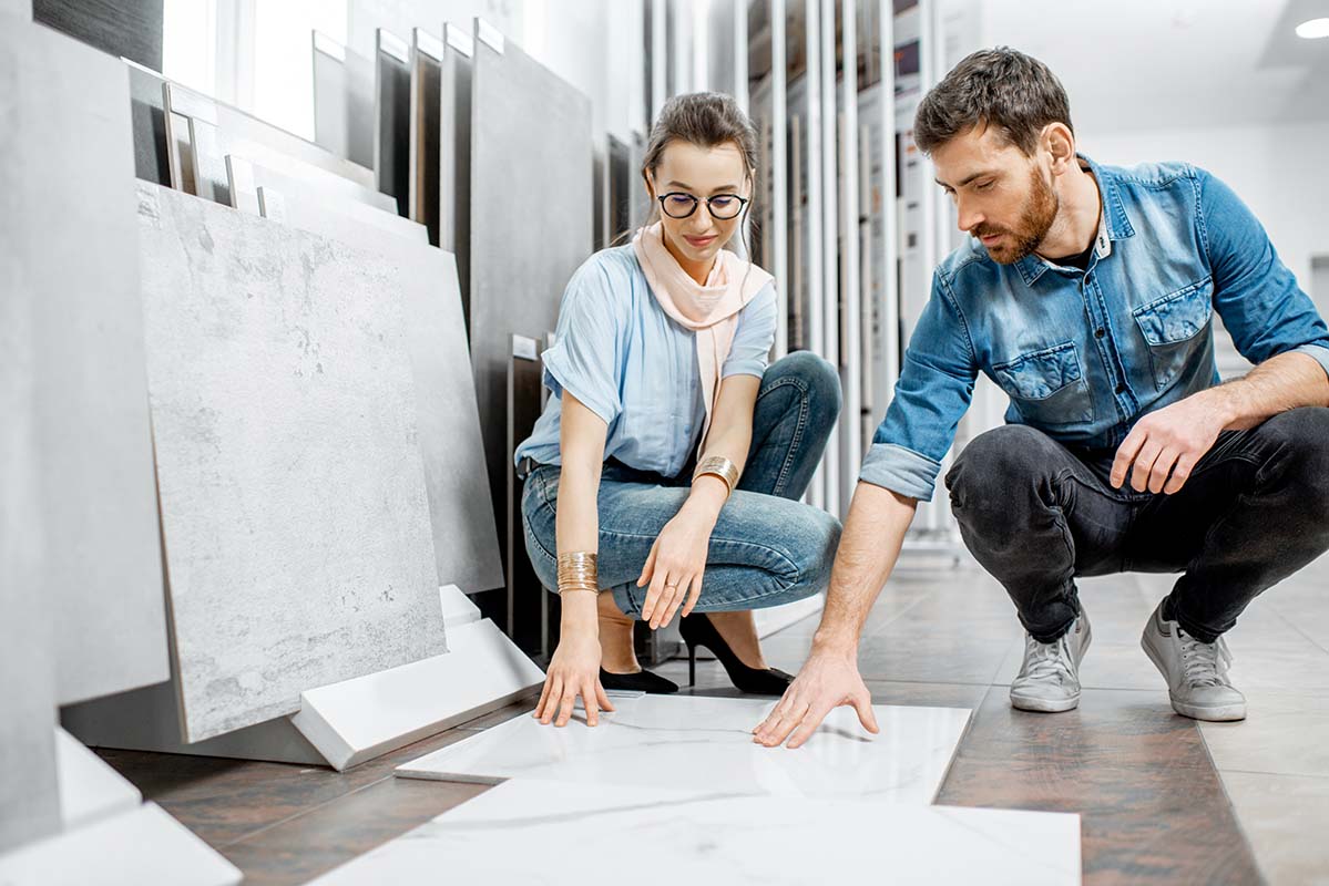 couple choosing tiles to install themselves in their kitchen