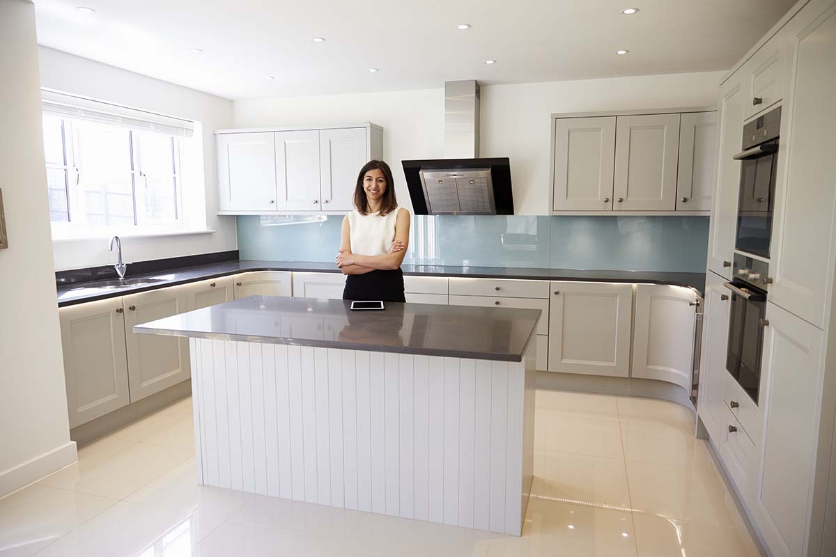 female real estate agent in a renovated kitchen
