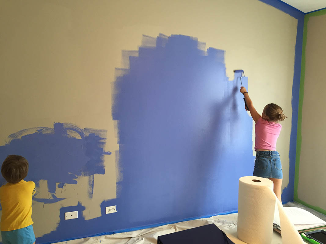 brother and sister painting their bedroom