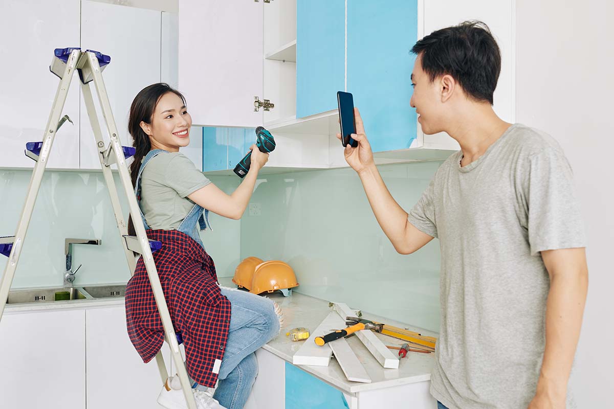 couple doing DIY kitchen renovation