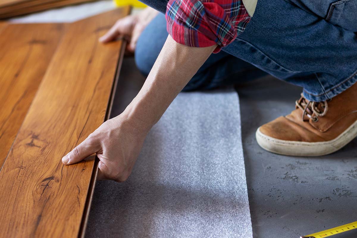 worker installing kitchen flooring