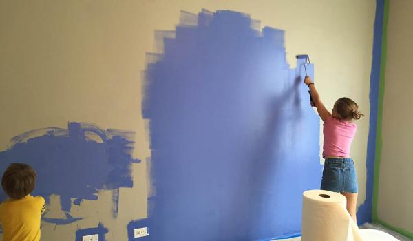 brother and sister painting their bedroom